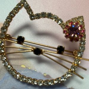 Hello Kitty pin or brooch completely blinged-out with rose colored metal
